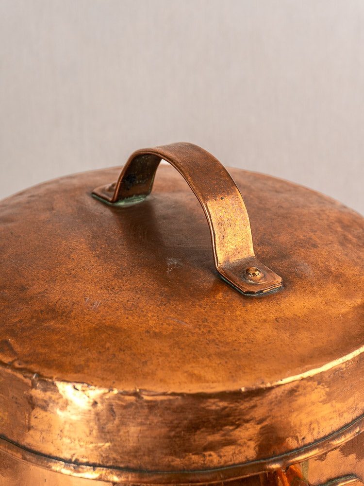 Hand-hammered copper lid from a 19th-century French cauldron, rich patina and curved handled secured with screws.