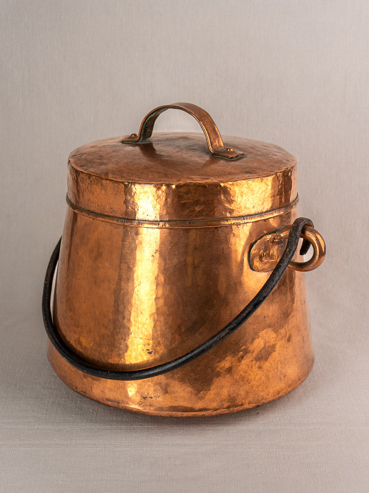 Antique French copper cauldron, 19th-century hand-hammered marmite with lid, side handle, and black metal bail.