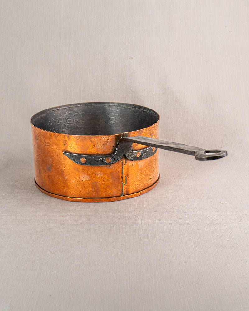 Set of four vintage French Jean Goardère copper saucepans with dark interiors and sturdy handles.