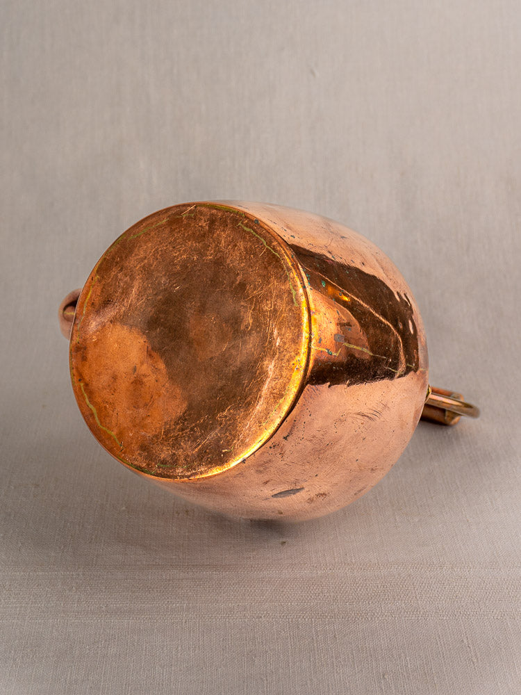Antique French copper tea kettle with wood handle, late 19th century, tarnished patina on gray background.