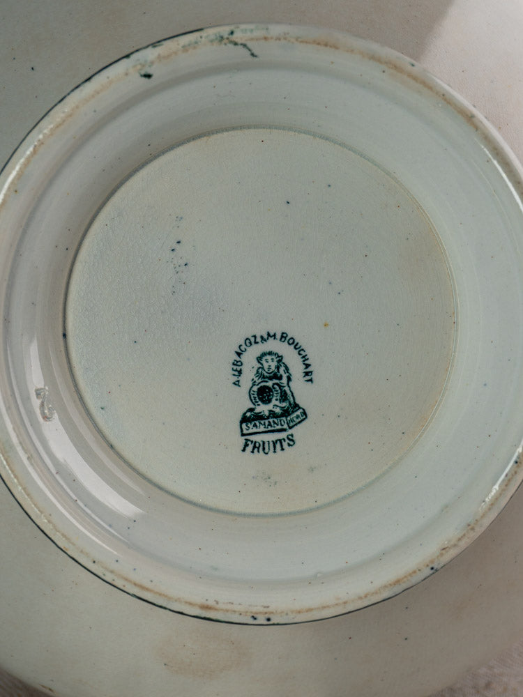 Underside of ceramic bowl with “ALEX GZLM BOUJUM, BAYNARD 1833, FRUITS” maker’s mark and emblem.