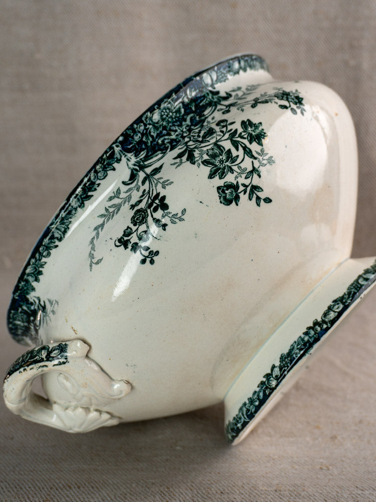 Antique French Saint-Amand faience soupière with handle, dark fruit motif, on textured fabric.