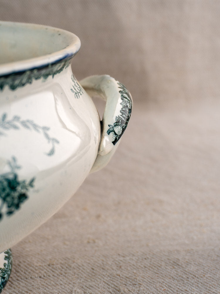 Antique French Saint-Amand faience soupière handle with Fruits Pattern, on neutral textured fabric.