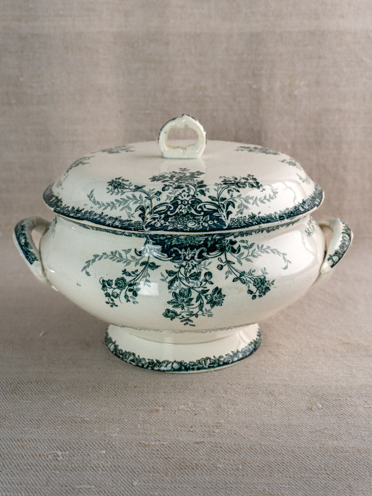 Antique French Saint-Amand faience soupière with lid, dark green floral design, on neutral fabric.