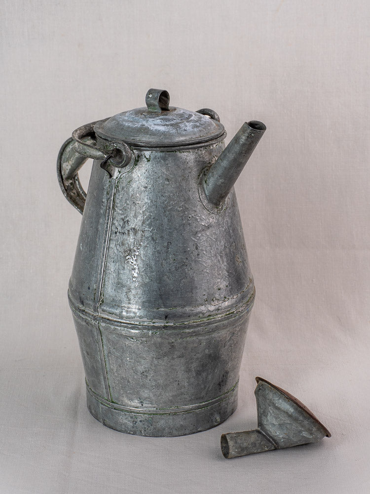 Antique French zinc watering can with milk can shape and metal funnel, displayed on a neutral cloth background.