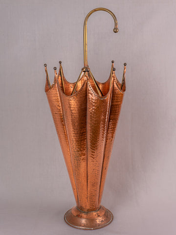 Mid-century French umbrella stand in hammered copper with flared top and curved brass handle.