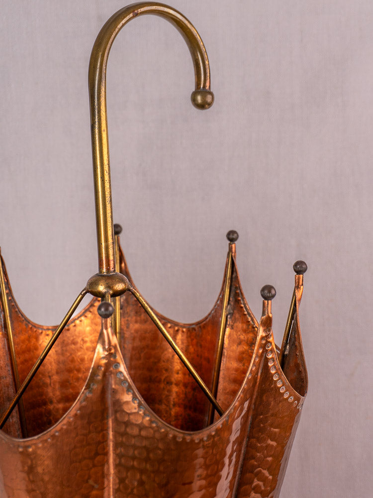 Vintage French umbrella stand in hammered copper with brass accents, open umbrella shape, mid-century design.