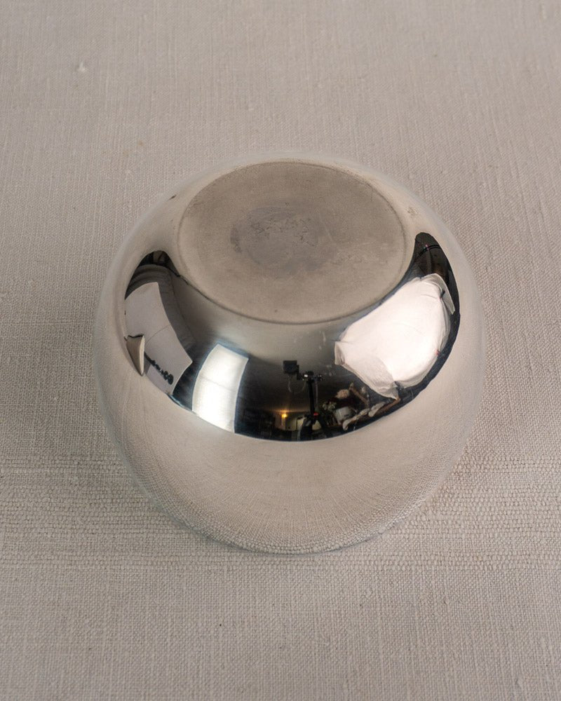 Mid-century French stainless steel pear ice bucket with matte base on a textured surface.