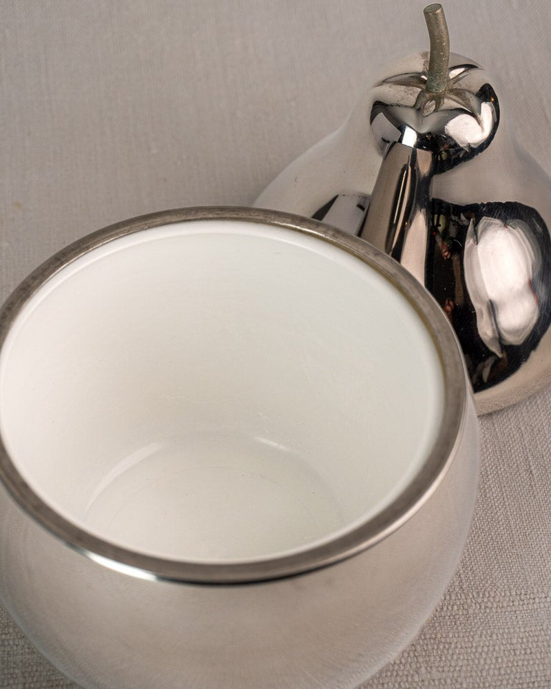 Vintage French stainless steel pear-shaped ice bucket from the 1960s on light grey textured surface.