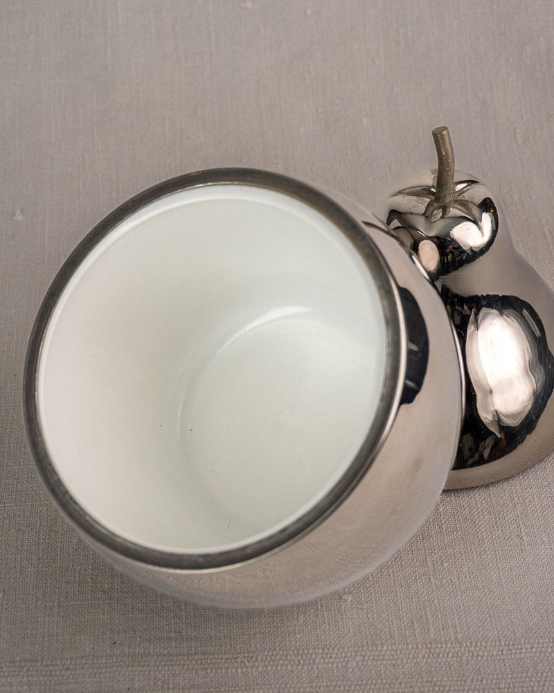 Vintage French pear-shaped silver stainless steel ice bucket with lid resting on gray textured surface.