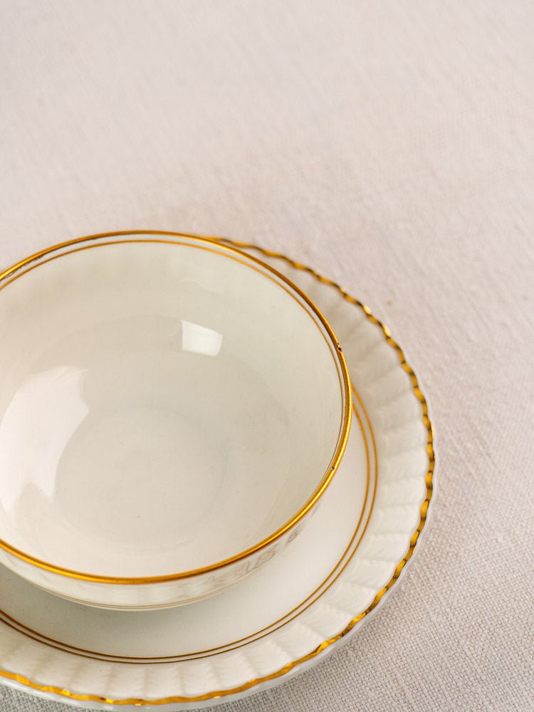 White Bernardaud porcelain bowl, plate, and saucer with gold rims from antique French Limoges tea set.