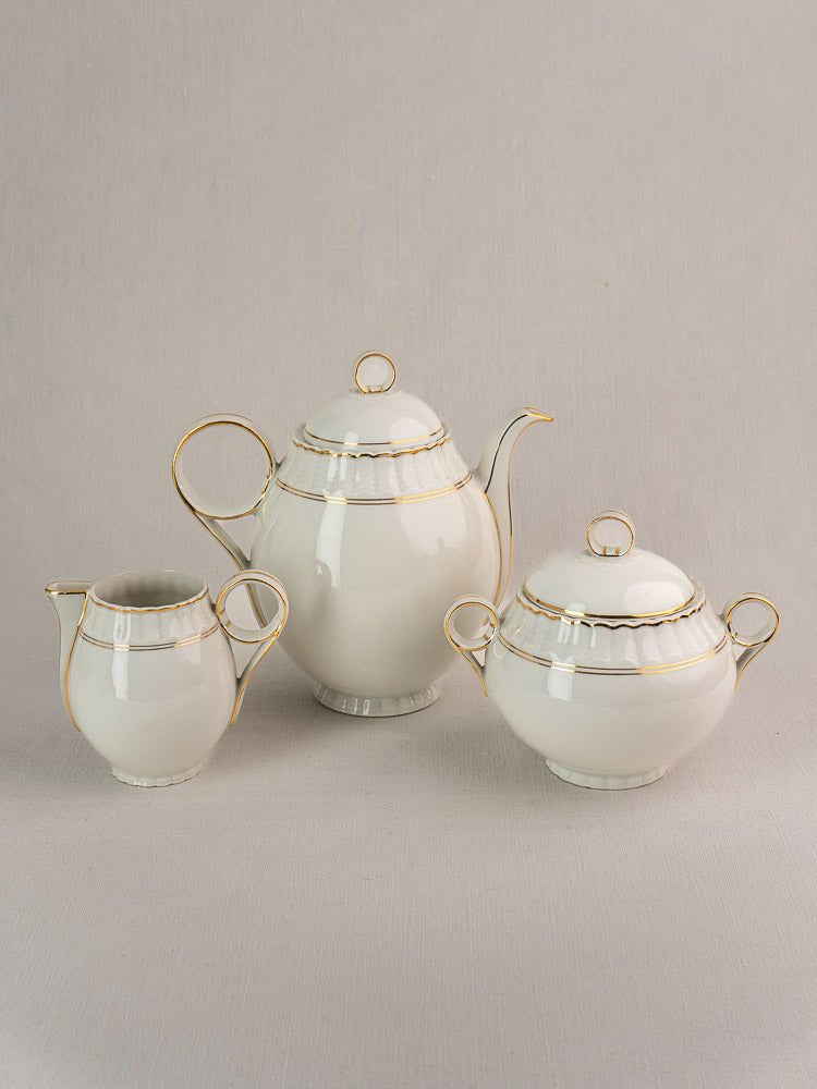Antique French Limoges tea set by Bernardaud, white porcelain with gold trim, circa 1900.