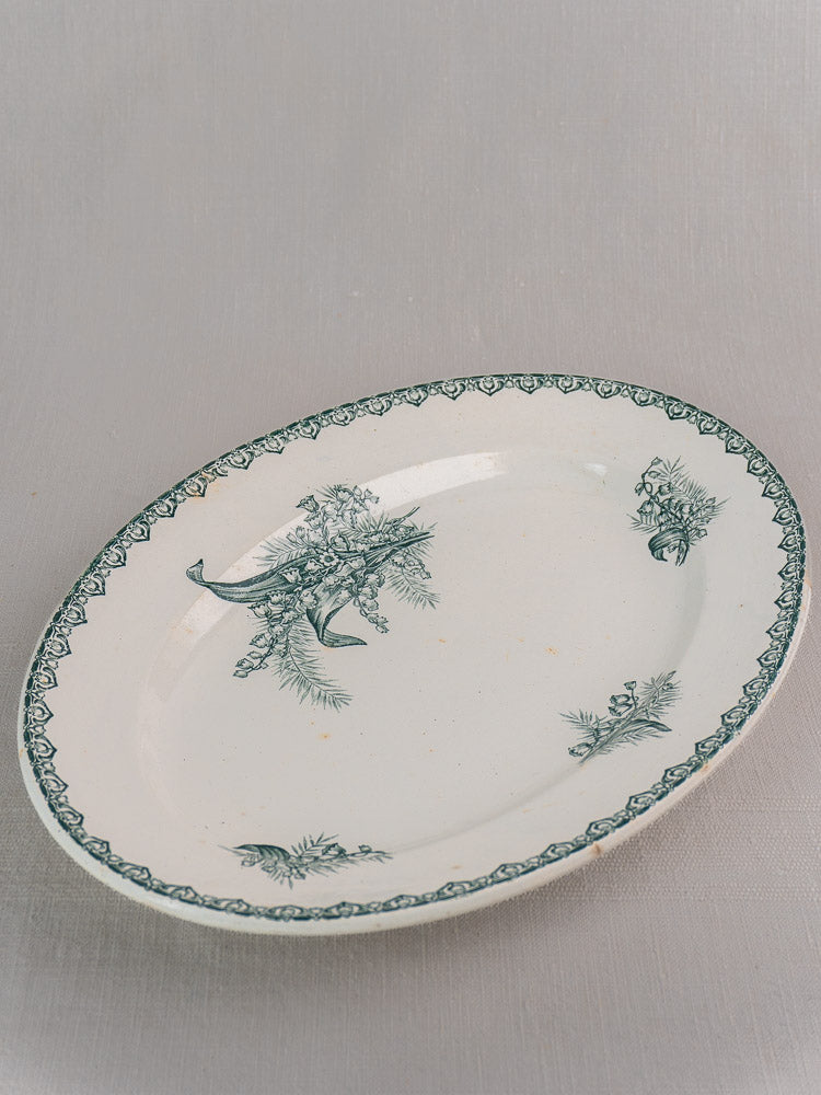 Antique French Saint Amand five-piece faience platter set with green floral motifs on white ceramic, light gray background.