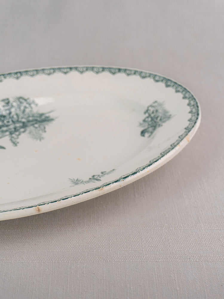 Antique French Saint Amand Muguet faience platter, white ceramic with green floral rim, minor edge chips.