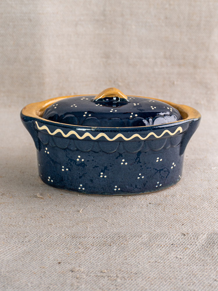 Antique French Soufflenheim cobalt blue covered terrine with duck motif on beige textured fabric.