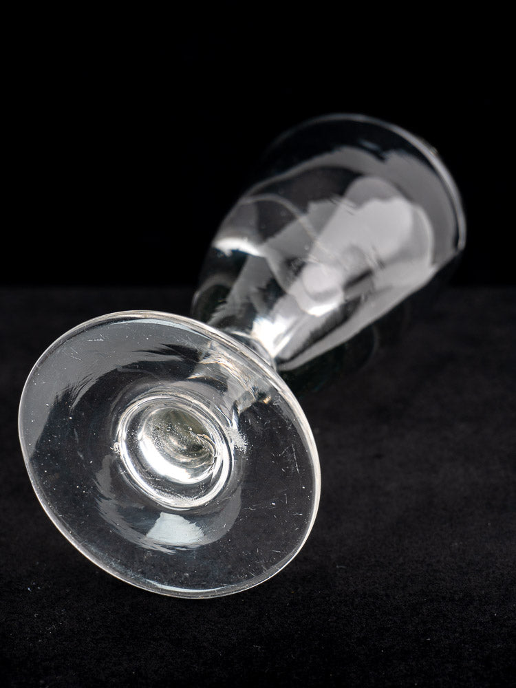 Set of four antique French uranium absinthe glasses, hand blown, displayed on a black surface.