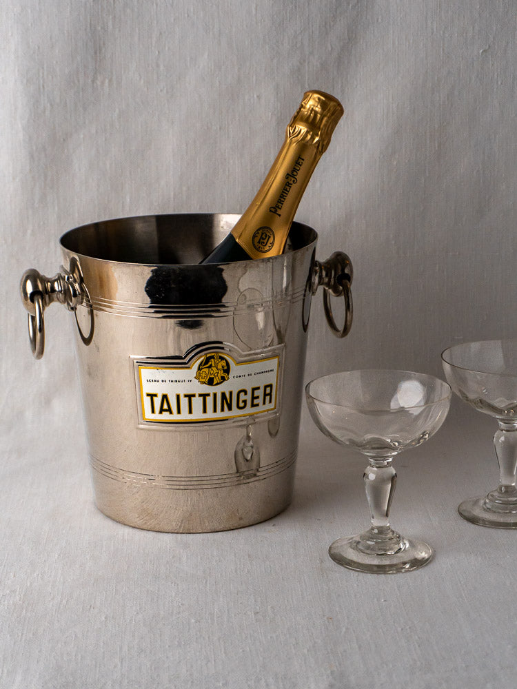 Vintage French Taittinger Champagne Bucket with bottle and two coupe glasses on white surface.
