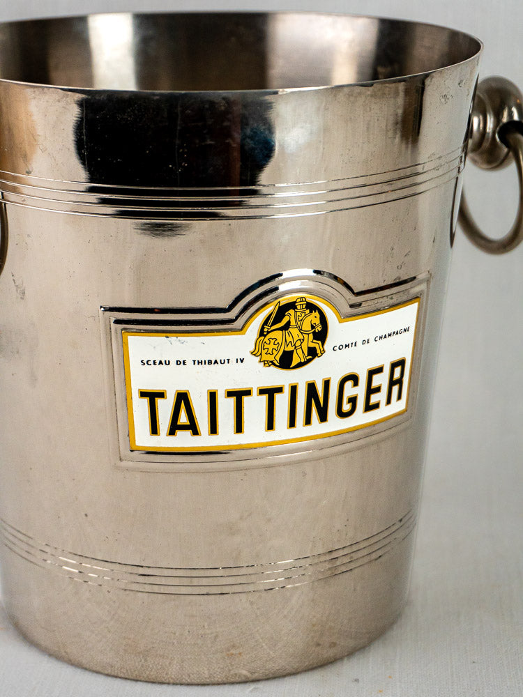 Vintage French silver-plated Taittinger champagne bucket with side handles and white-gold label.