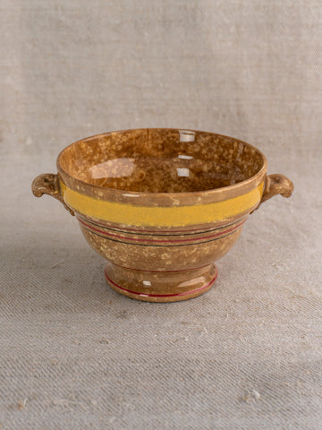 Antique French faience bowl by HB et Cie Choisy-le-Roi with handles, yellow rim stripe, red accents on beige fabric.