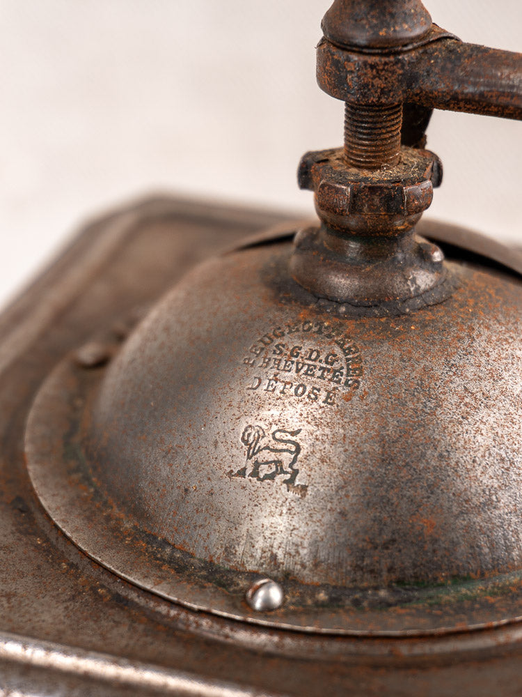Antique French Peugeot Frères tinned steel coffee mill, late 19th century, with engraved details and lion logo.