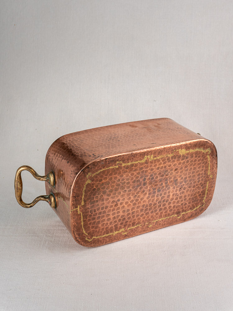 Antique French copper daubière, 19th century, hand-hammered, patina, brass handle, flat marked base against neutral background.