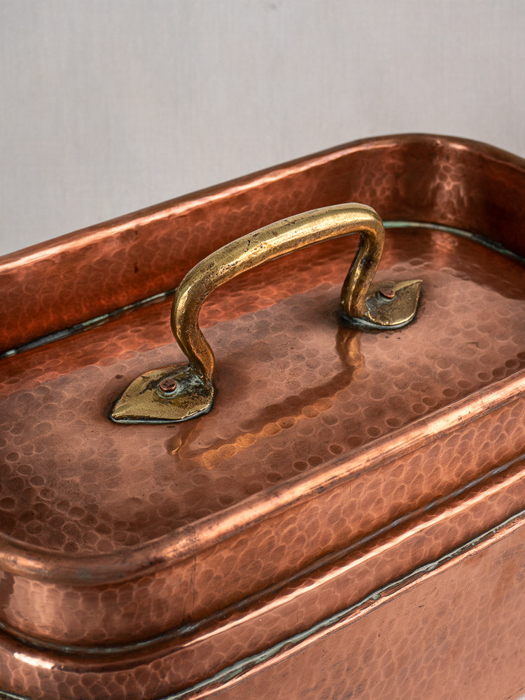 Antique French copper daubière, 19th-century hand-hammered pan with textured surface and brass lid handle.