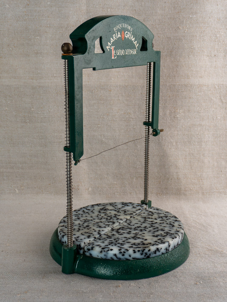 Vintage French Roquefort cheese cutter, 1960s Maria Grimal, wire mechanism, speckled marble base on textured fabric.