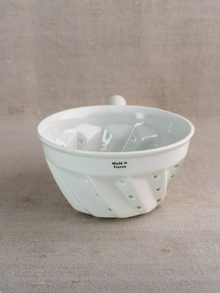 Vintage French porcelain berry strainer with copper ring, diagonal ridges, and “Made in France” mark.
