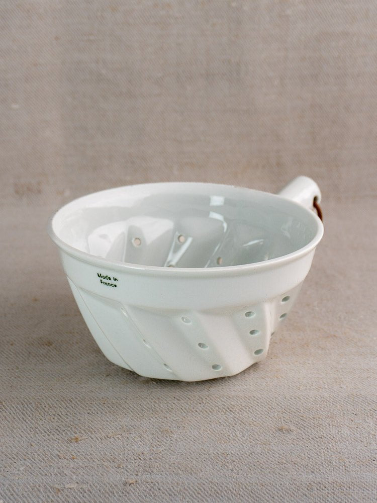 Vintage French white ceramic colander with copper ring, diagonal grooves, and “Made in France” label.