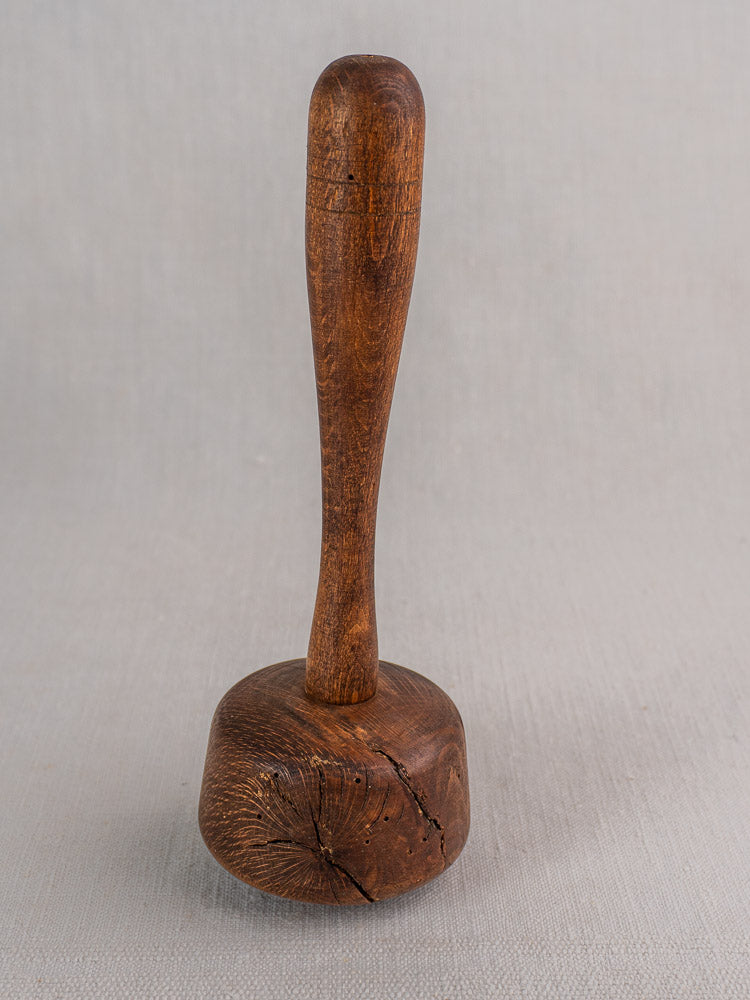 Set of three antique French turned hardwood mallets with rounded handles and cylindrical heads, showing natural grain and cracks.